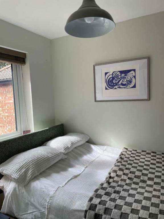 a bedroom with a bed with a black and white blanket at Bedroom 2 with a little loo in King's Lynn