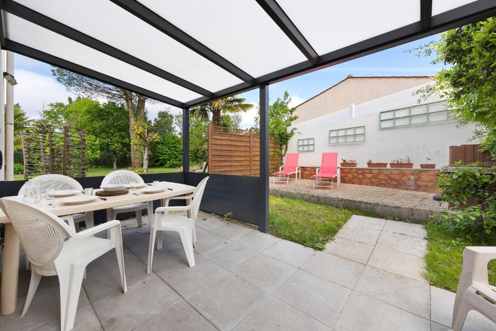 a patio with a table and chairs on a patio at Gîte 4 Pers L'étoile De Mer in Apremont