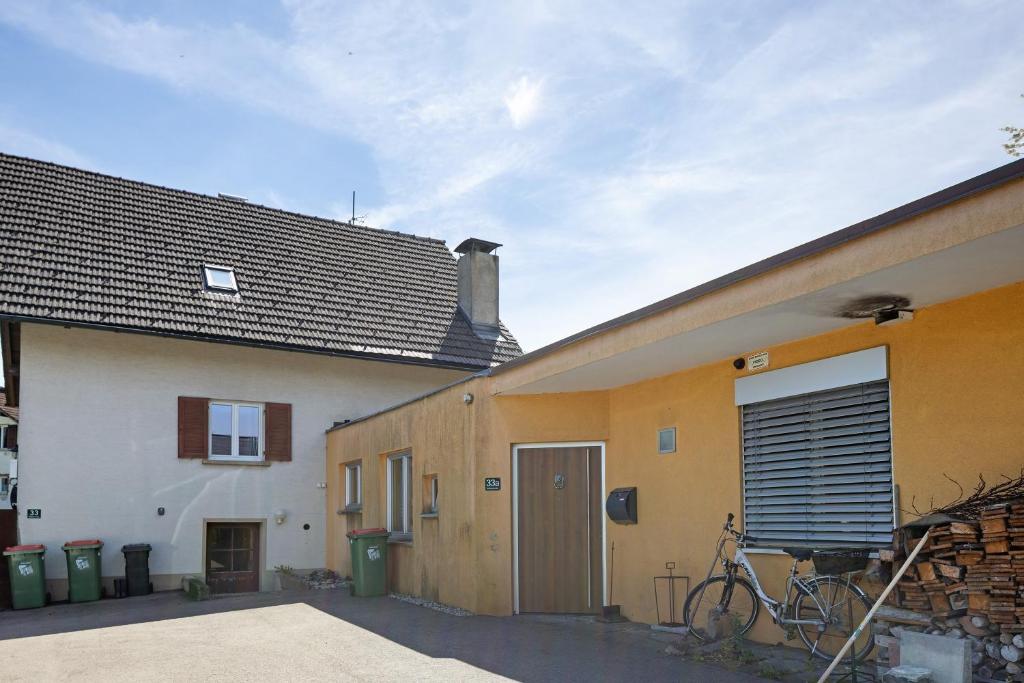 a bike parked next to a building with a garage at Appartement Panoramablick in Lustenau
