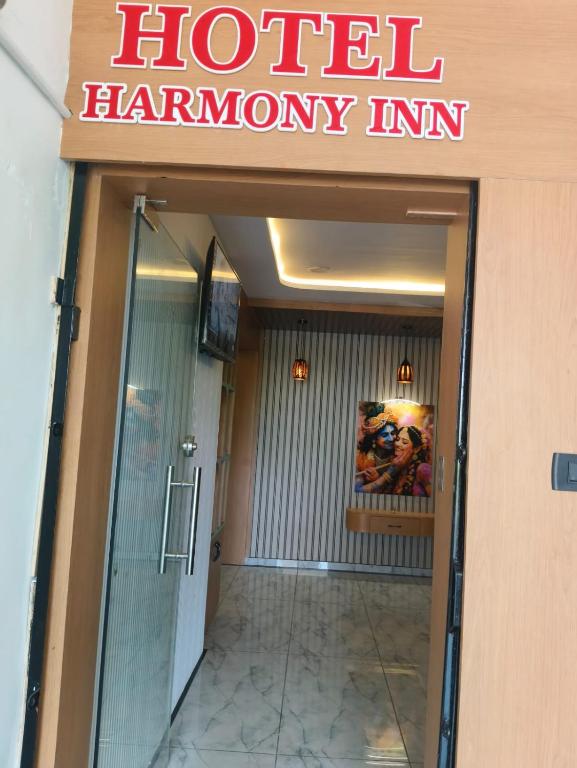 a hotel hallway with a sign on the front of a building at Hotel Harmony Inn in Ahmedabad