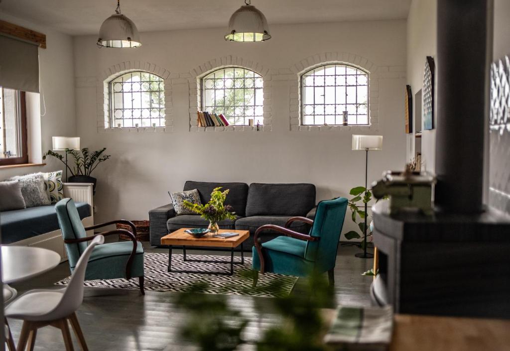 a living room with a couch and chairs at TÉGED VÁRTALaK in Dörgicse
