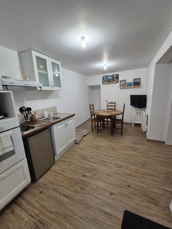 a kitchen and dining room with a table in it at Studio Les Sapins in Chapois