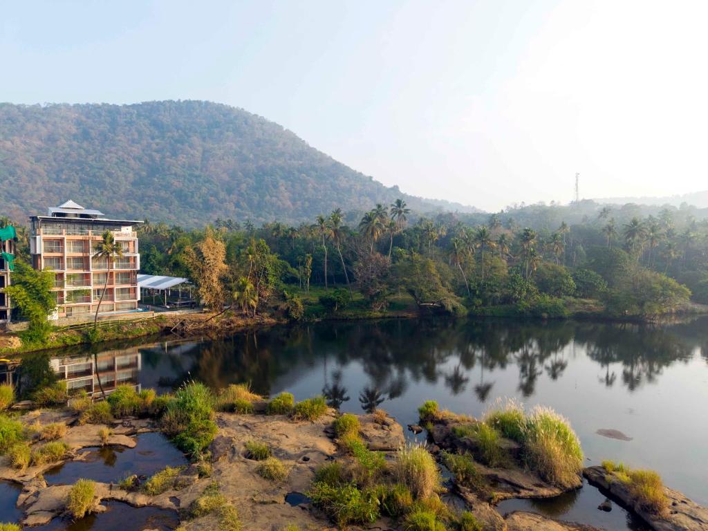 a building on the side of a river at River Bay Athirappilly in Athirappilly