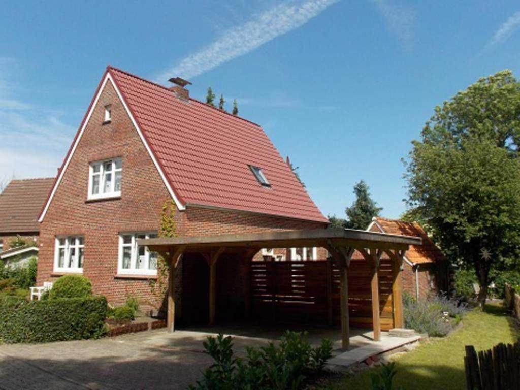 a large brick house with a red roof at Ferienhaus Dieknuest, 15172 in Leer