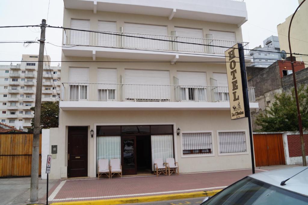 a white building with chairs in front of it at La Cibeles in Miramar