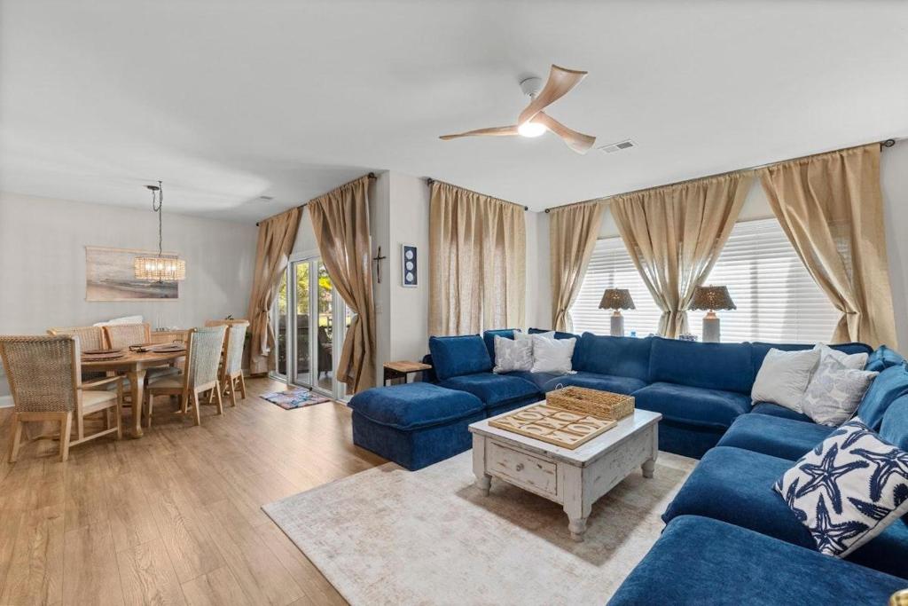 a living room with a blue couch and a table at Marsh Breeze Hideaway at Masters Place in Pawleys Island