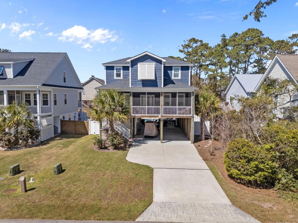 an aerial view of a house with a driveway at Pool Spa Fire Pit & More at this OKI Escape in Oak Island