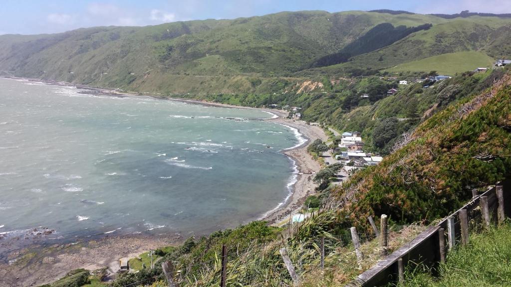 a view of the ocean from a hill at Kapiti Waves in Pukerua Bay