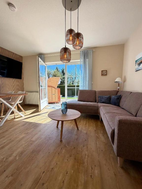 a living room with a couch and a table at Backhuus 3 in Fehmarn