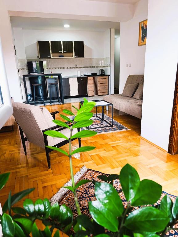 a living room with a couch and a table at Hera Sweet Apartment in Niš