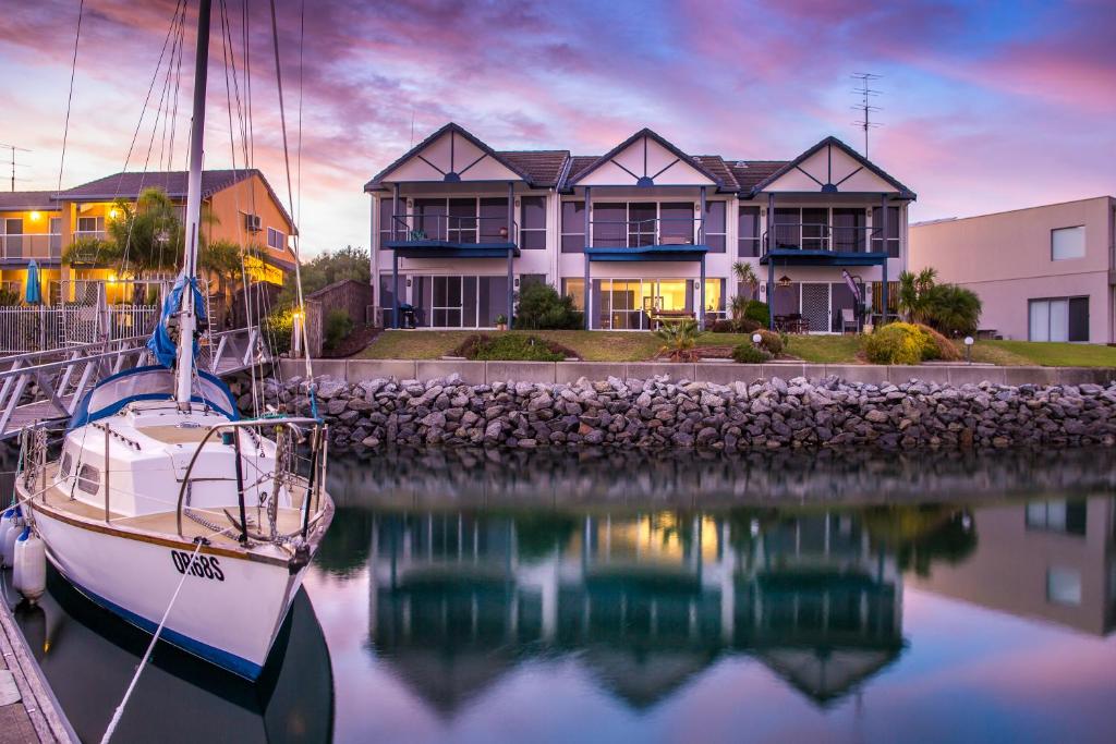 a boat is docked in front of a house at Marina Reflections in Port Lincoln