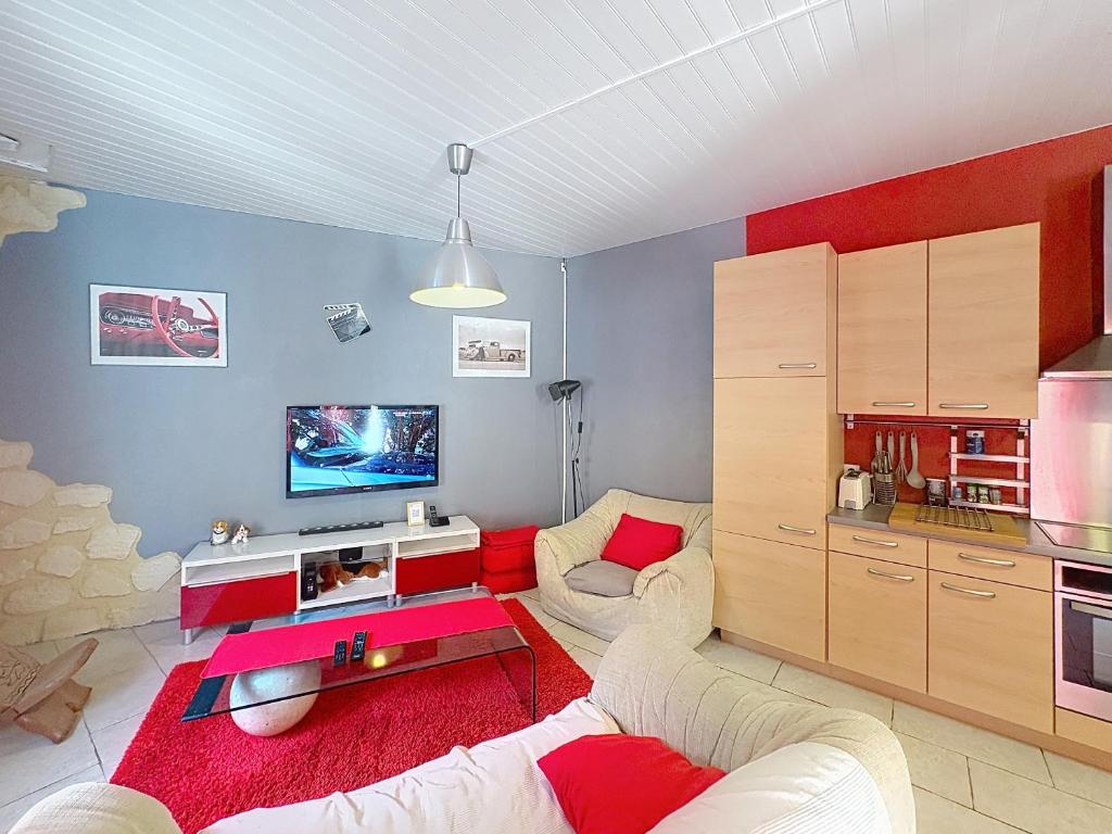 a living room with a couch and a table at La Petite Riau in Seillonnaz