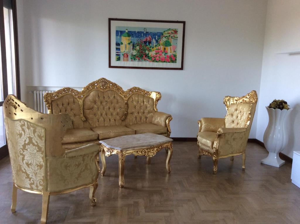 a living room with a couch and two chairs at Magellano Room in Verona