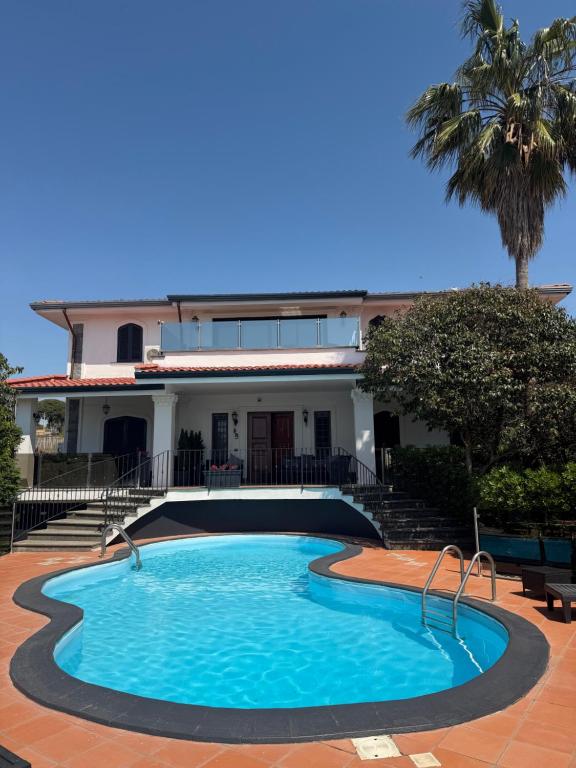 a swimming pool in front of a house at B&B Villa Nunzia in Ercolano