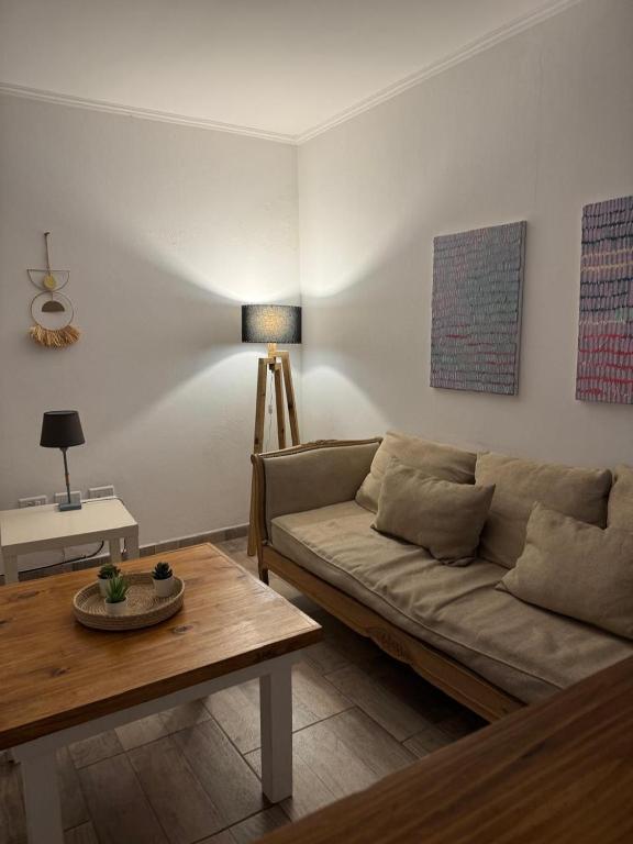 a living room with a couch and a table at SoHo Flat in Tandil