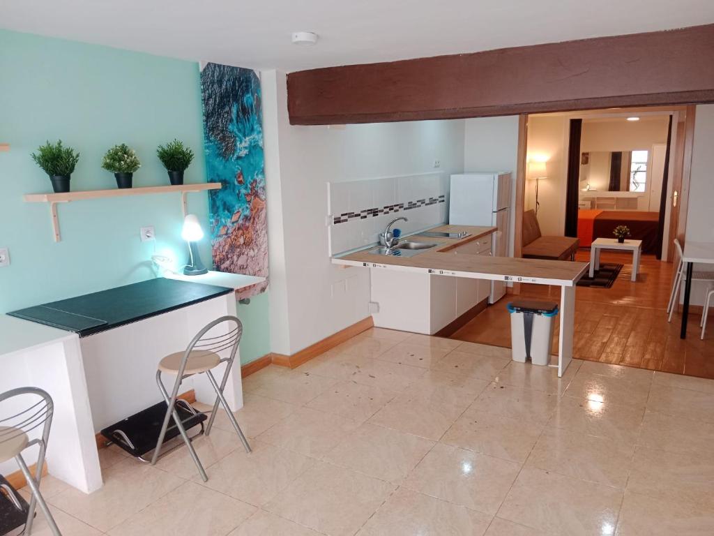 a kitchen with a table and chairs in a room at Loft Centrico Bahia 2 in Santander