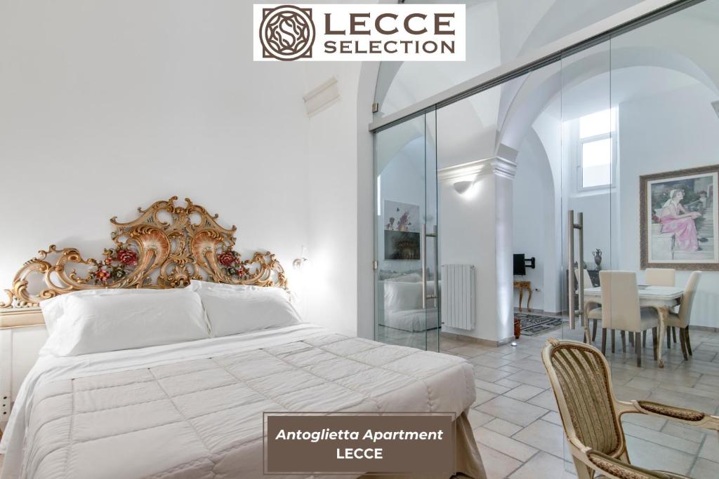 a bedroom with a large bed and a dining room at Antoglietta Suites Lecce Selection in Lecce