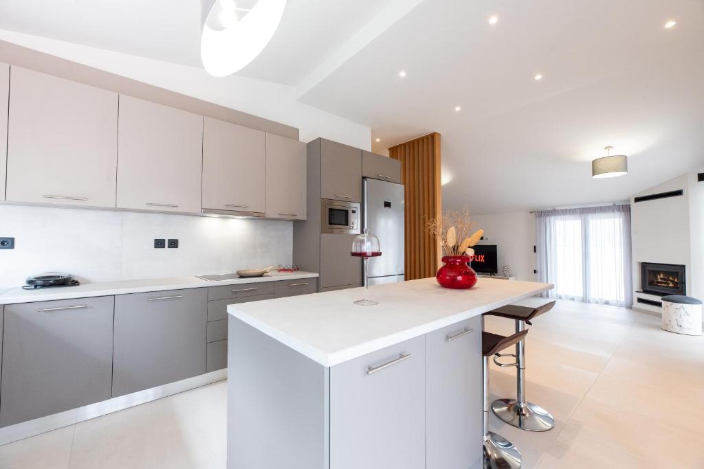 a kitchen with white cabinets and a white counter top at Aelion Airport Residence By SEM in Artemida