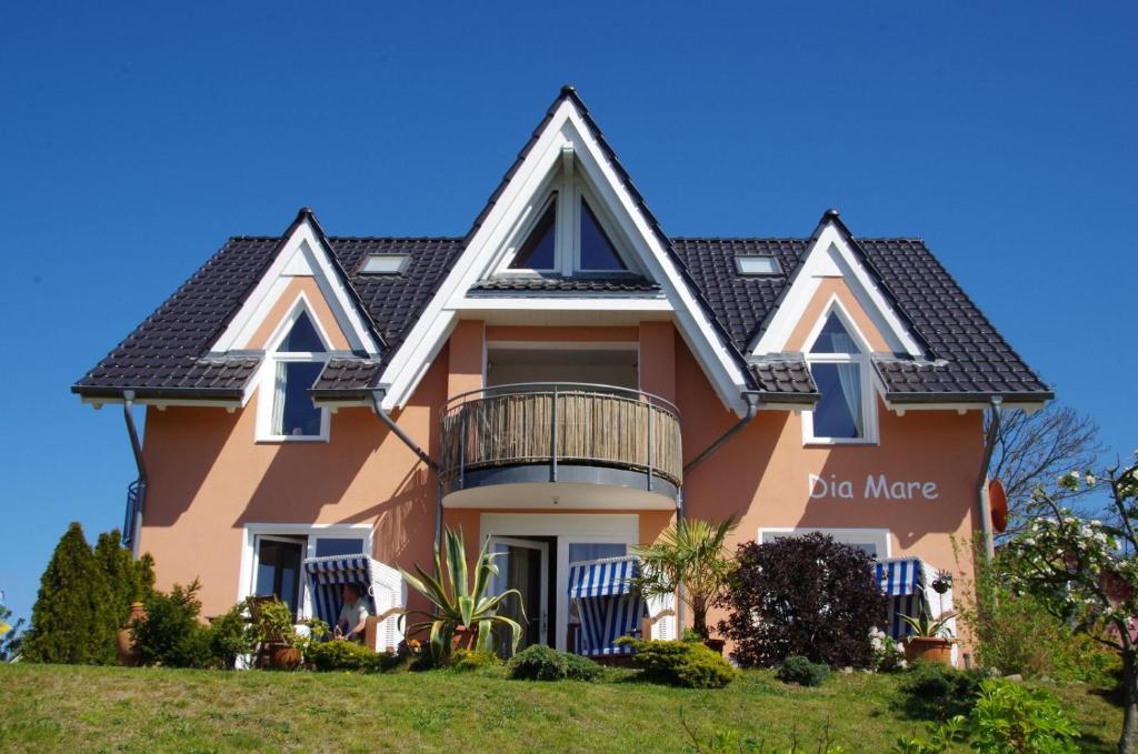 a large pink house with a black roof at Dia Mare in Ueckeritz