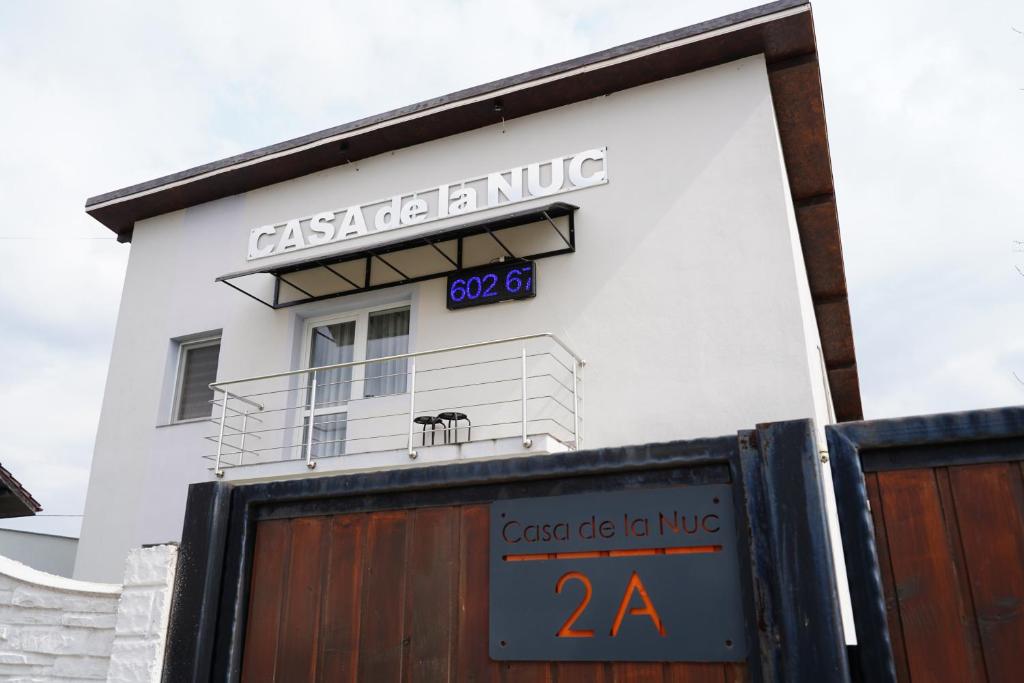 a building with a sign on the side of it at Casa de la Nuc in Târgu Jiu