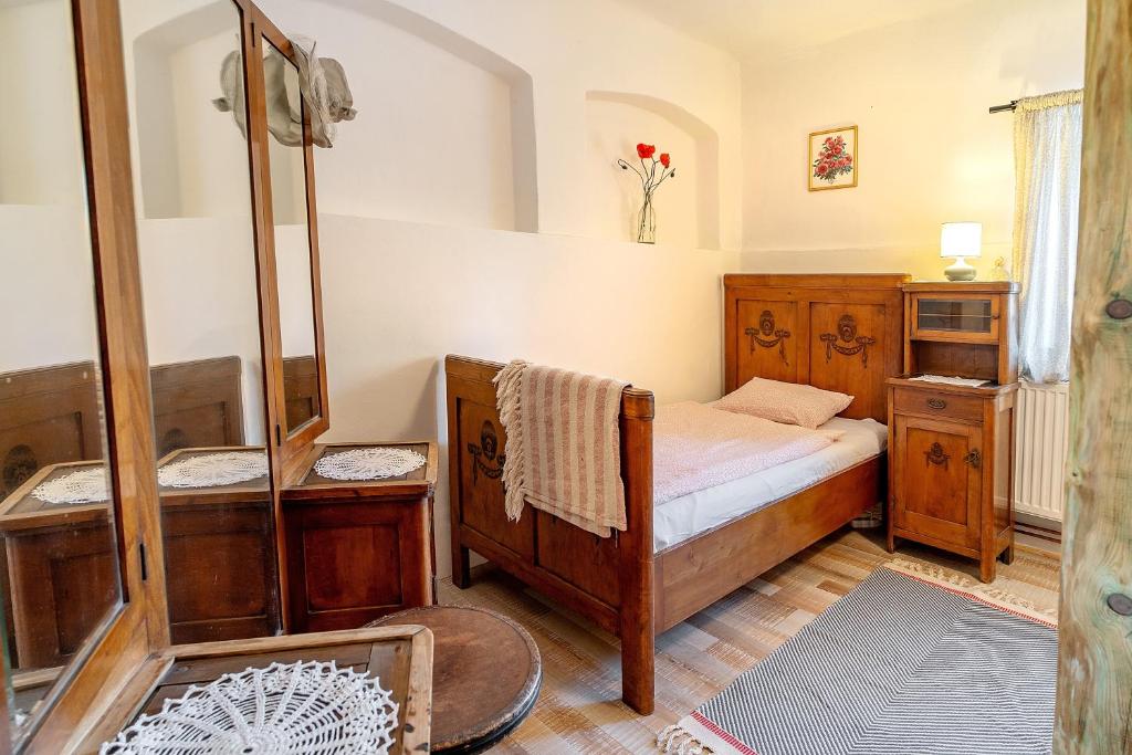 a small bedroom with a bed and a shower at Apartmán U babičky in Strakonice