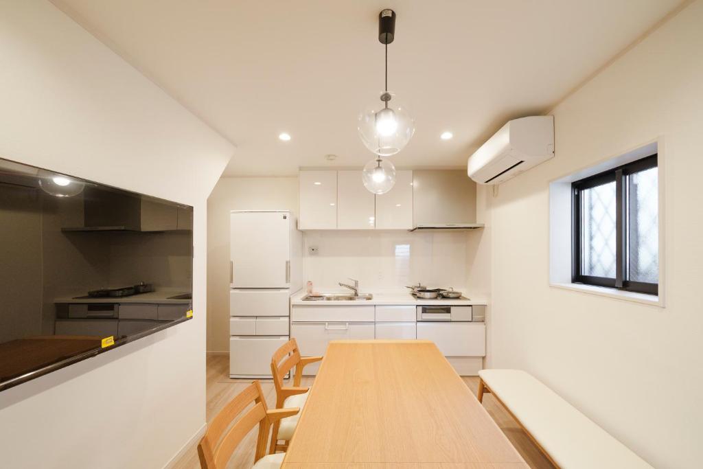 a kitchen with a wooden table in a room at the UNIT5 HOUSE Roppongi in Tokyo