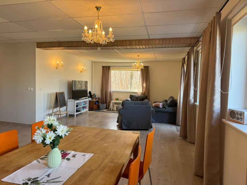a living room with a dining table and a living room at Konrad Guesthouse in Kuressaare