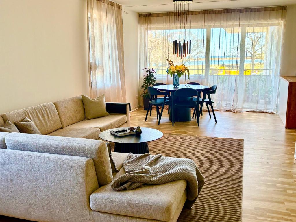a living room with a couch and a table at Seafront Lux Apt, Central, Beach, Direct Airport Metro in Copenhagen