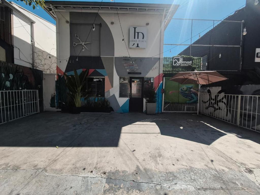 a building with a mural on the side of it at Nomad Hostel - Vila Madalena in São Paulo
