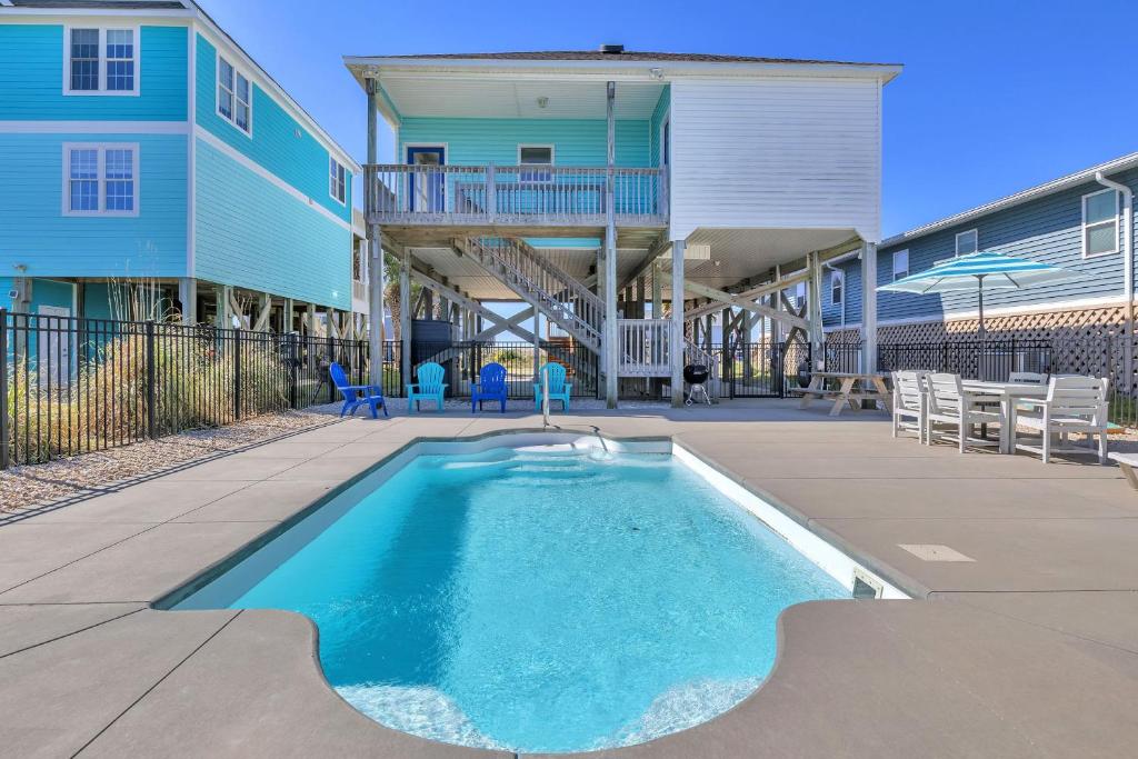 a swimming pool in front of a building with a house at Life Is Good in Oak Island