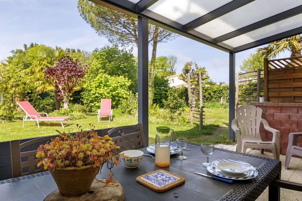 a table with plates and wine glasses on a patio at L'Océane in Apremont