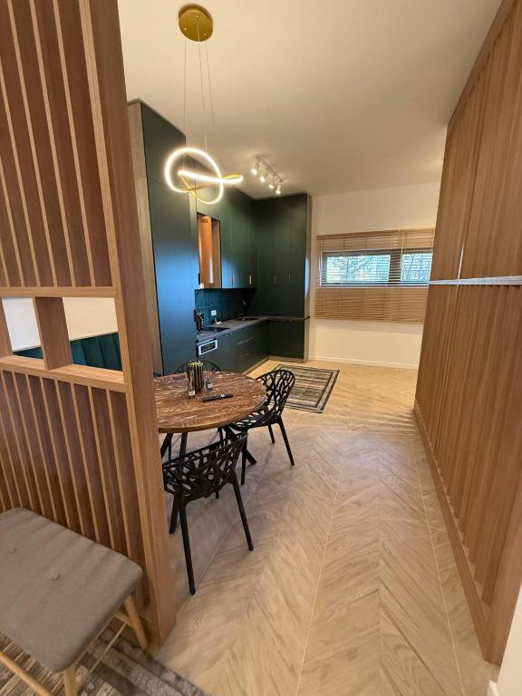 a dining room with a table and chairs at Tomis Villa Center Studio in Constanţa