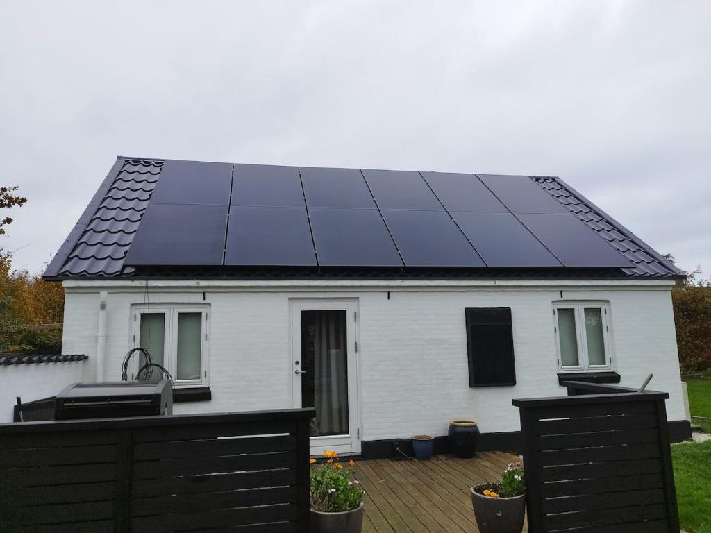 a house with solar panels on the roof at Small House ærø in Marstal