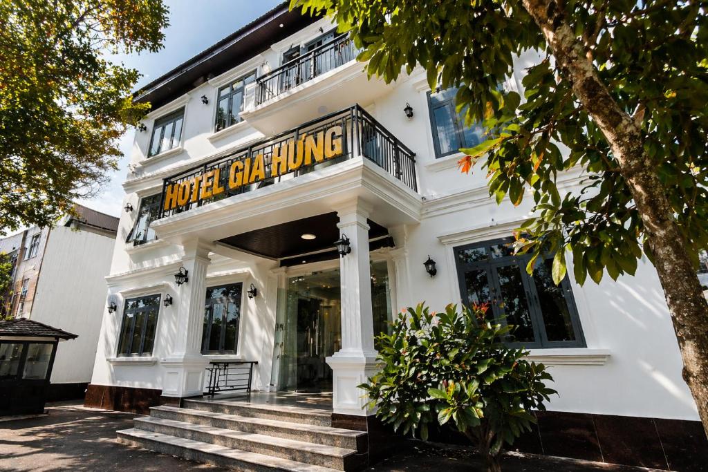 a white building with a sign that reads house drinking at Hotel Gia Hưng in Bảo Lộc