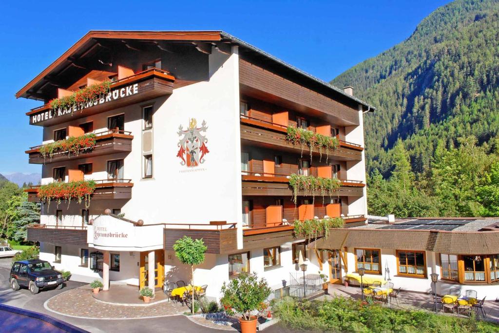a large building with flowers on the front of it at Hotel Kajetansbrücke in Pfunds