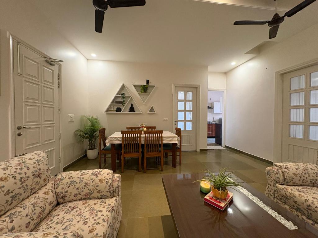 a living room with a couch and a table at Red Brick House in Panchkula