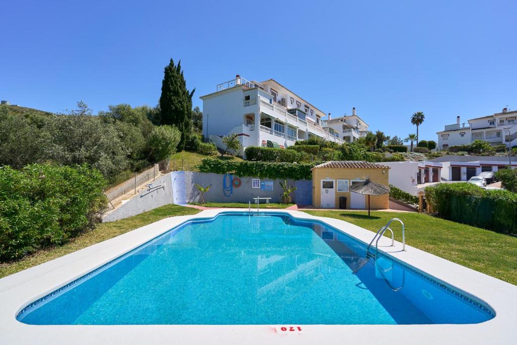 a villa with a swimming pool and a house at Apartamento Bellavista Torrox Park in Torrox