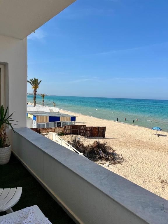 a view of the beach from the balcony of a condo at Waterside in Hammam Sousse