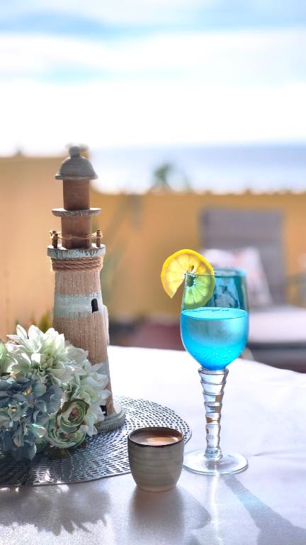 a blue drink in a glass on a table at Thelighthouse Porto Santo in Porto Santo