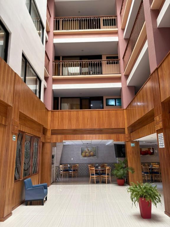 a view of the lobby of a building with tables and chairs at Oaxaca Inn Reforma in Oaxaca City