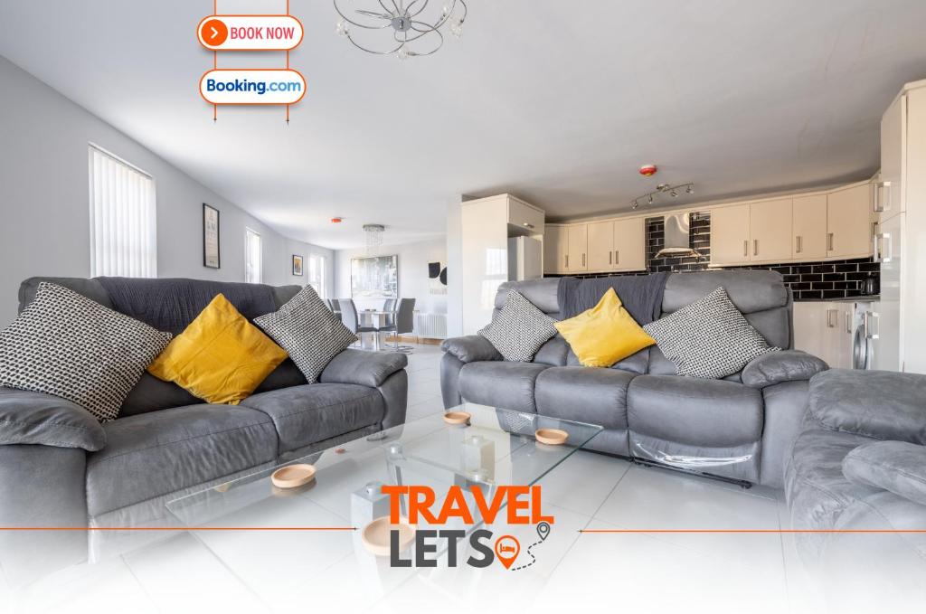 a living room with two couches and a glass table at Four Bedroom House By Travel Lets Self Catering Accommodation Ballygowan With Near Belfast in Ballygowan