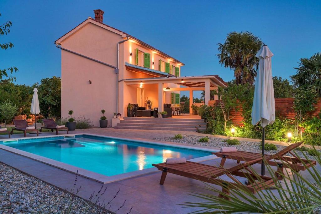 a home with a swimming pool and a house at Crassula Summer Villa with Private Pool in Kras