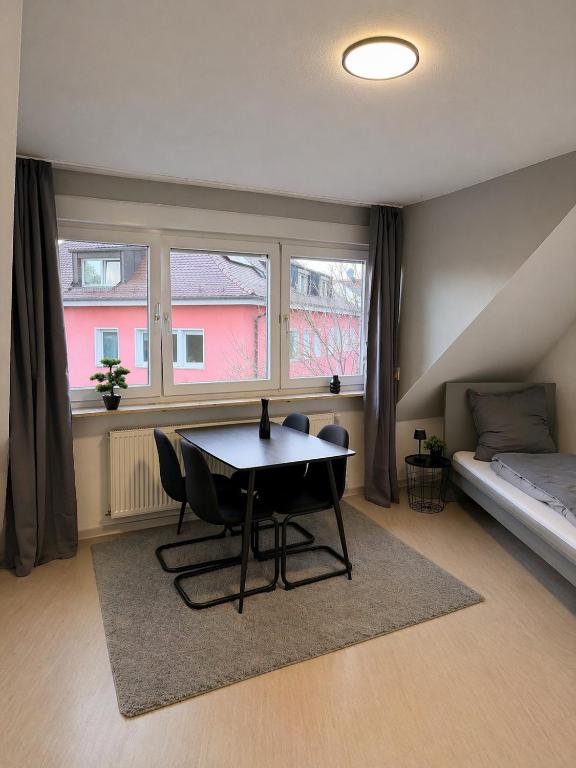 a room with a table and a bed and a window at Apartment Kist bei Würzburg in Kist