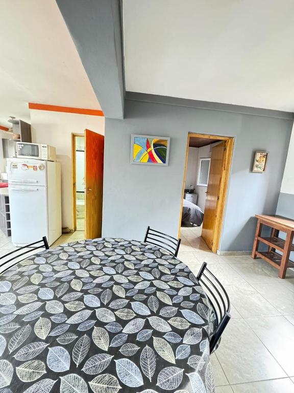 a table and chairs in a room with a kitchen at Patagonia y Deloqui in Ushuaia