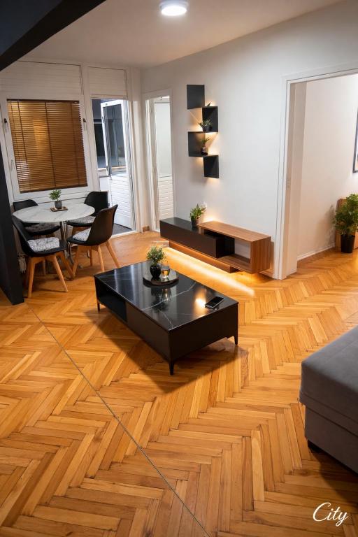 a living room with a black coffee table and a couch at Apartman City With 3 Bedooms And Free Parking in Negotin