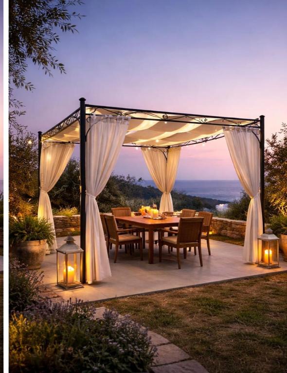 a patio with a table and a canopy with lights at Amaranthus house in Longós