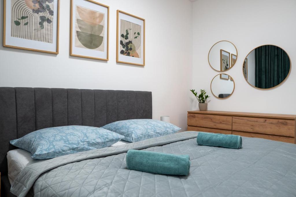 a bedroom with a large bed with blue pillows at Pod Hajom 101 in Liptovský Mikuláš