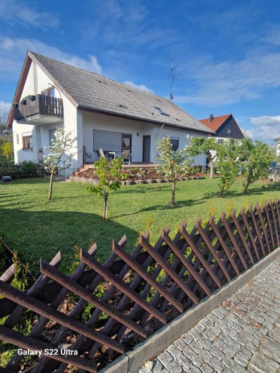 a wooden fence in front of a house at Zimmer zu vermieten in Rammingen
