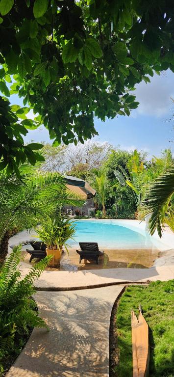 a swimming pool with a picnic table next to it at Villas Boutique Antheia in La Orilla
