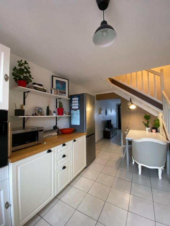 a kitchen with a tub and a sink and a table at Maison de ville quartier saint-pierre in Brest